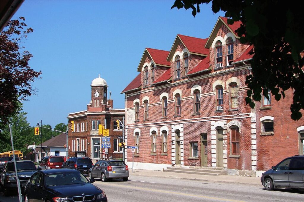 Street view of red brick buildings and clock tower in Orangeville.