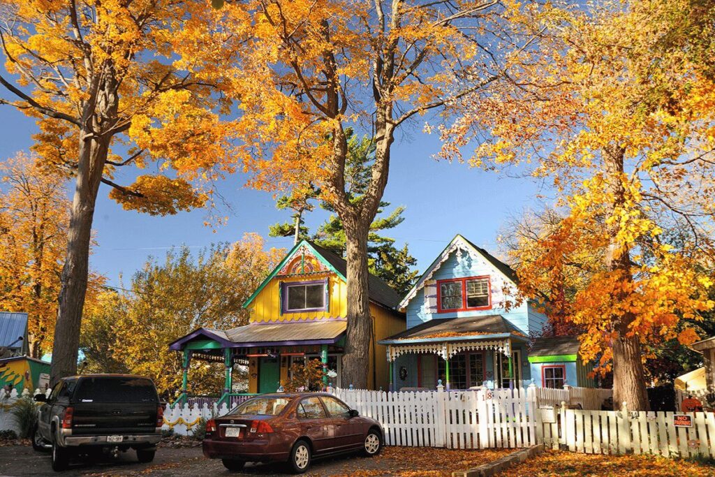 Vibrant cottages with fall trees and parked cars in Bayfield, Ontario.