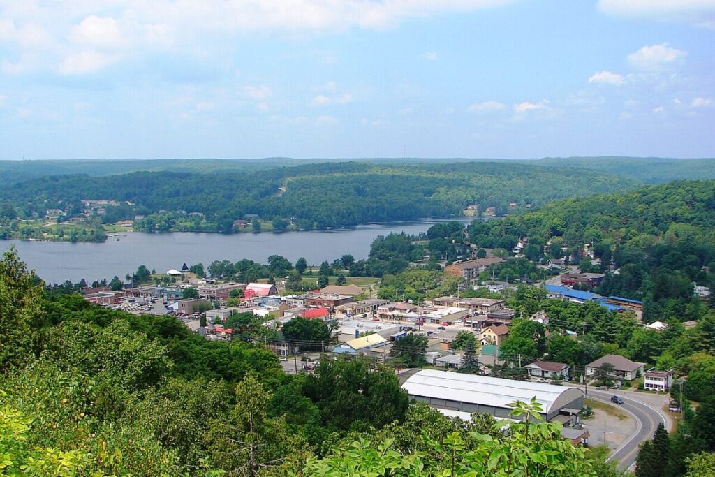 Scenic overlook of Haliburton’s downtown and nearby forested lake.