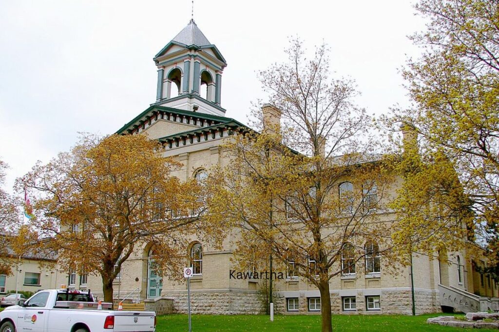 Old stone courthouse surrounded by fall foliage in Kawartha Lakes.