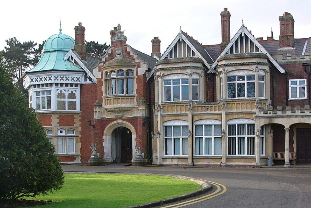 Historic Bletchley Park estate featuring ornate windows and turrets.