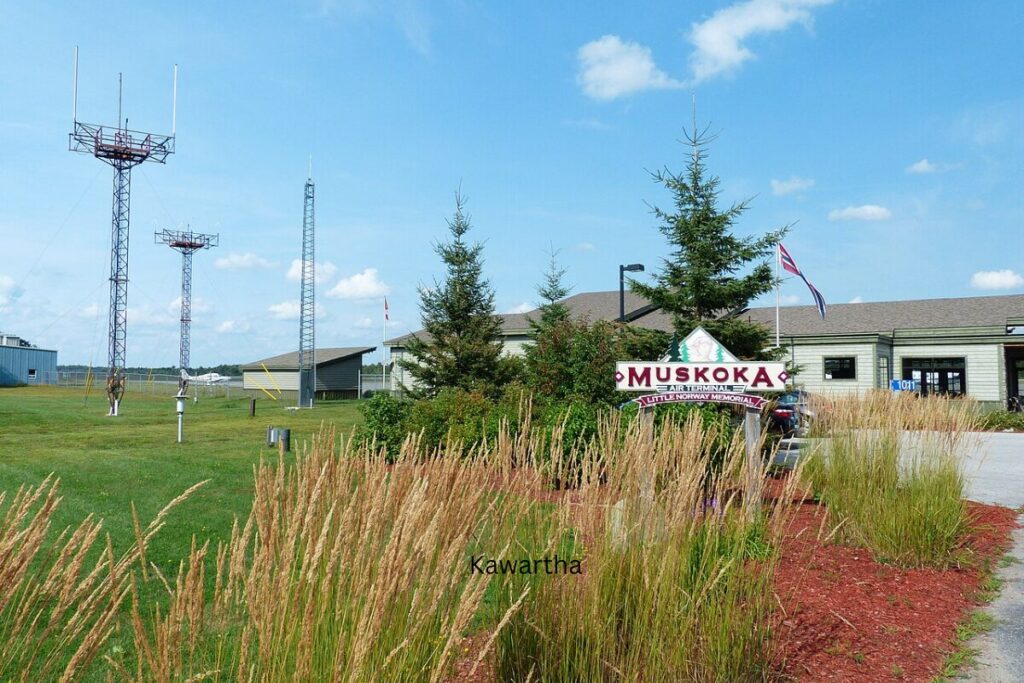 Muskoka Airport terminal with welcome sign and communication towers.