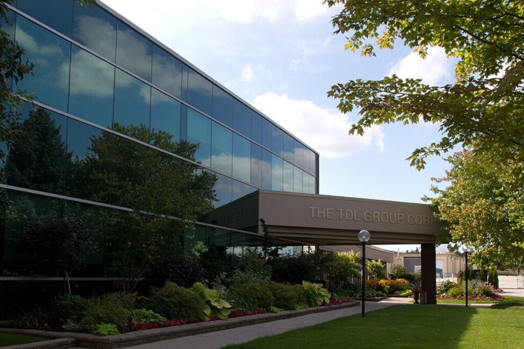 Glass office building of TDL Group surrounded by greenery in Oakville.